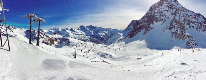 Scenic view of snow covered mountains against sky