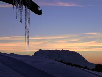 Scenic view of silhouette mountain against sky at sunset