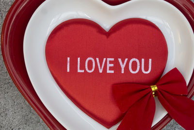 Close-up of red heart shape text on white background