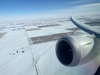 Close-up of airplane wing against sky