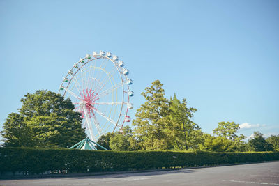 Low angle view of ferris wheel against sky