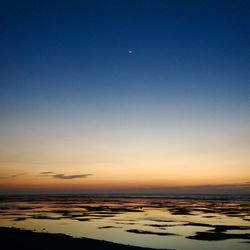 Scenic view of sea against clear sky at night