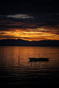 Scenic view of lake against orange sky