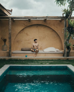 Full length of shirtless man in swimming pool