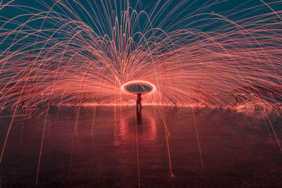 Low angle view of firework display at night