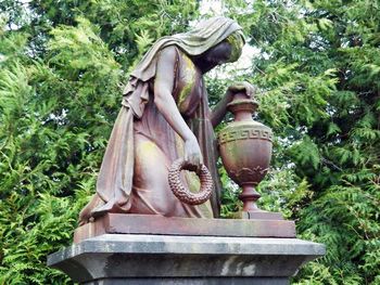 Close-up of statue against trees
