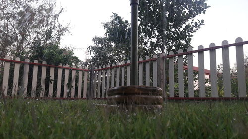 Fence on field against clear sky