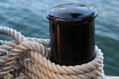 Close-up of rope tied on wooden post