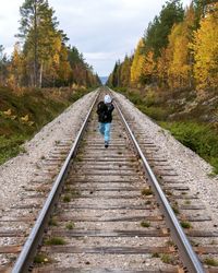 Boy running on railroad track