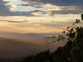 Scenic view of mountains against sky at sunset
