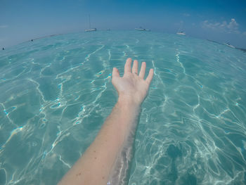 Midsection of woman swimming in sea