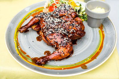 Close-up of chicken in plate on table