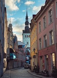 Street amidst buildings against sky in city