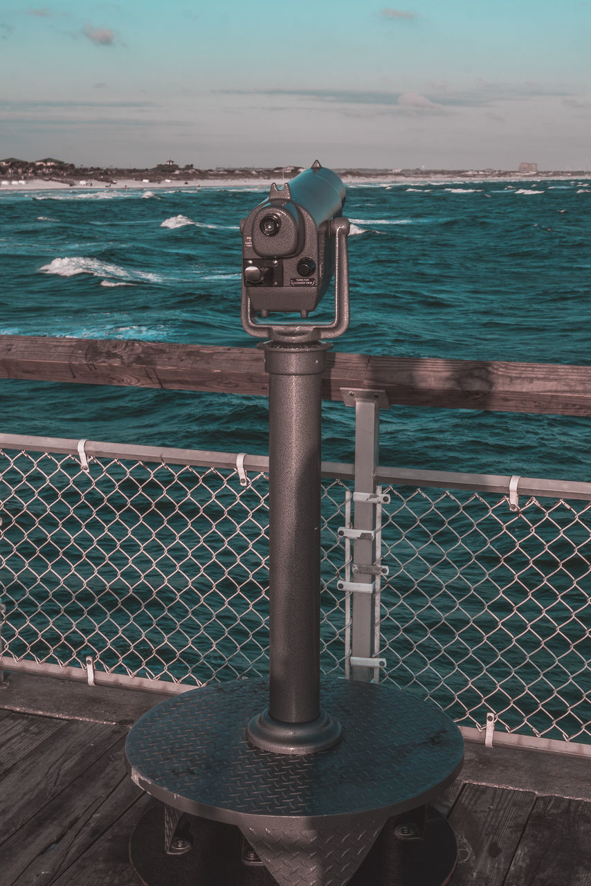 sea, water, sky, nature, security, blue, binoculars, coin-operated binoculars, metal, no people, railing, horizon over water, coin operated, ocean, horizon, day, protection, scenics - nature, outdoors, beauty in nature, land, beach, tranquility, cloud, fence, tranquil scene, iron, travel destinations