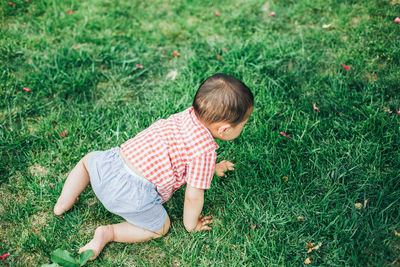 High angle view of boy relaxing on grass