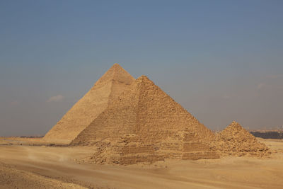 Stone wall in desert against sky