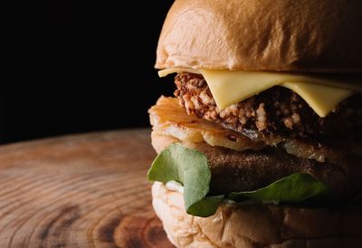 Close-up of burger against black background