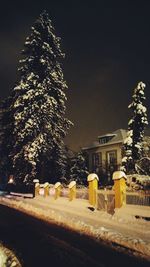 Illuminated buildings against sky at night