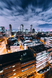 Illuminated cityscape against sky