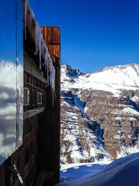 Scenic view of snowcapped mountains against clear blue sky