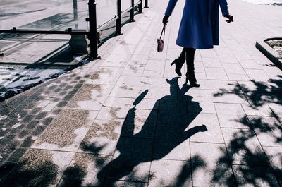 Low section of woman on street