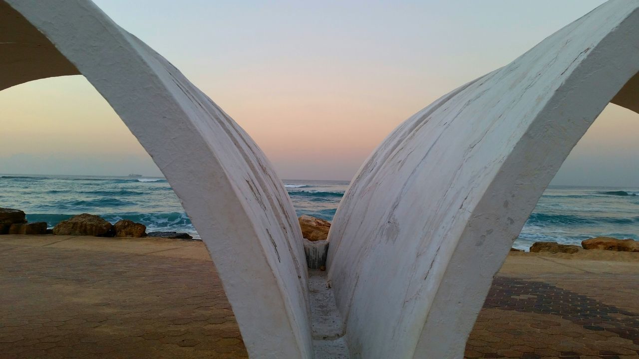 sea, horizon over water, water, beach, built structure, architecture, sunset, sky, scenics, shore, clear sky, sunlight, nature, tranquil scene, beauty in nature, tranquility, coastline, sand, sun, railing