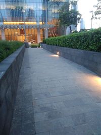 Footpath amidst buildings in city