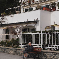 Man sitting against building