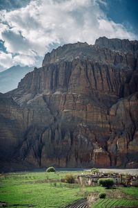 Scenic view of mountain against cloudy sky