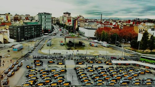 High angle view of traffic on road by buildings against sky