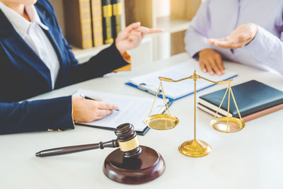 Close-up of people on table