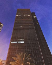 Low angle view of modern building against blue sky