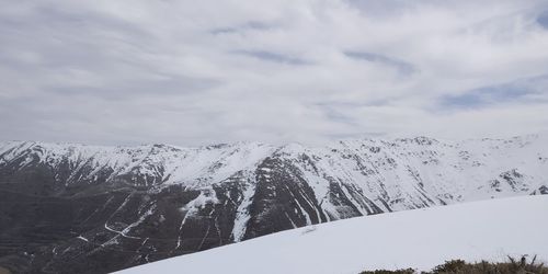 Scenic view of snowcapped mountains against sky