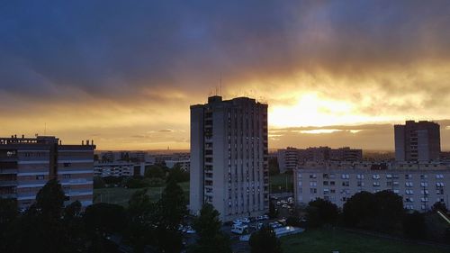 View of cityscape against cloudy sky during sunset