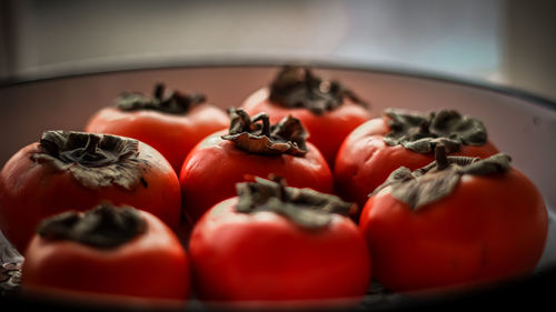 Close-up of chopped persimmons in plate on table