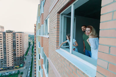 Family standing against window