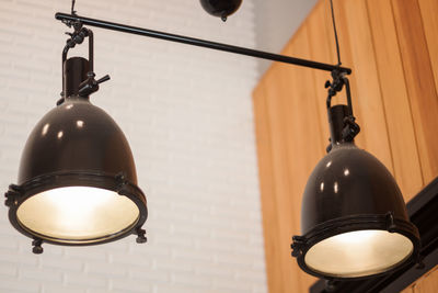 Low angle view of illuminated lamp hanging on ceiling