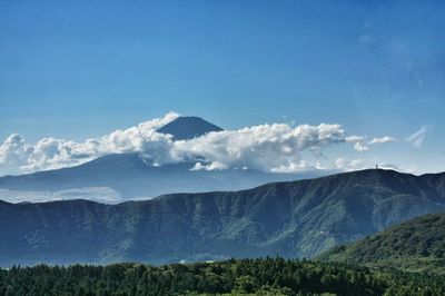 Scenic view of mountains against blue sky