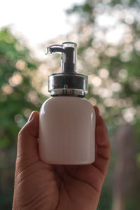 Close-up of person holding bottle