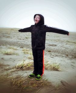 Full length of boy standing on beach