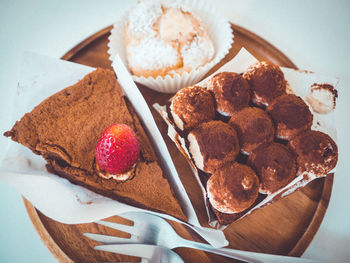 Chocolate cake topping with fresh strawberry and drinks placed on table in cafe. style minimal.