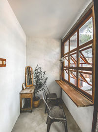 Empty chairs and table against wall at home