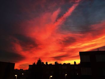 Silhouette city against sky during sunset