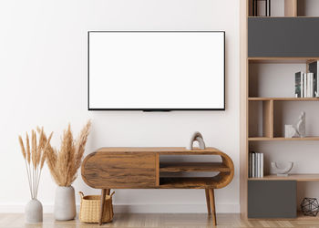 Led tv with blank white screen, hanging on the wall at home. tv mock up. copy space 