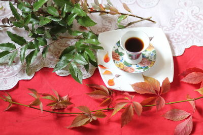 High angle view of coffee and roses on table