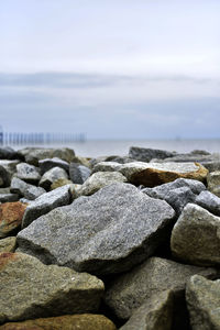 Rocks on beach against sky