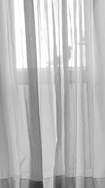 White curtain hanging on window at home