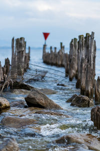 Rocks in sea against sky