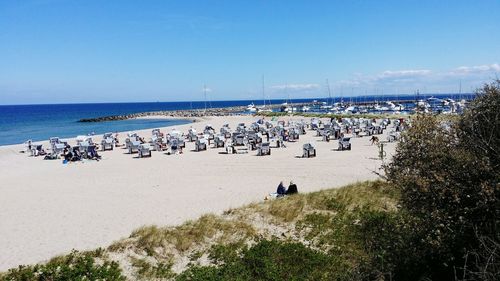 People on beach against sky