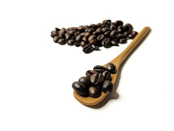 High angle view of coffee beans against white background